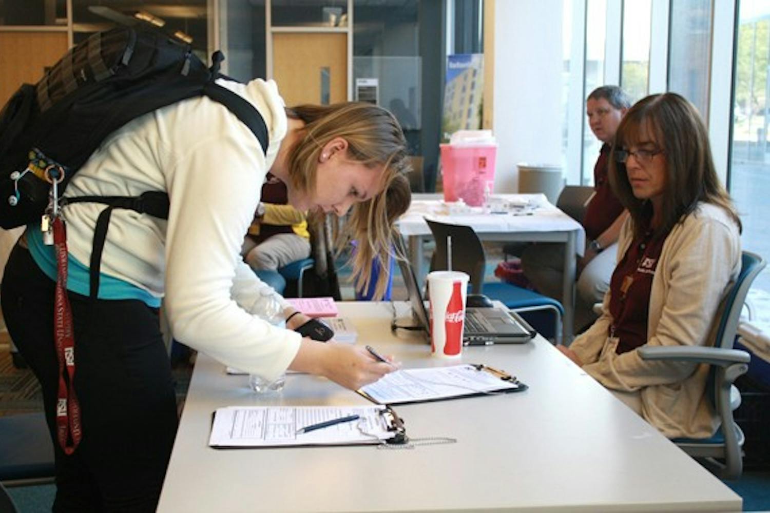 Katrece Swenson, a sophomore studying biological science attended the ASU Health Services Flu Clinic to get her shot for the season. As a peer mentor living in the dorms, she wants avoid if at all possible getting sick this flu season. (Photo by Hector Salas Almeida)