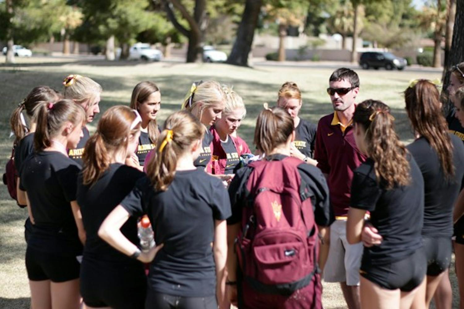 ASU women’s cross-country coach Ryan Cole talks with his team after the Pac-12 championships in October. The team has reached the NCAA Nationals in his first season as coach, thanks to solid performances at the West Regional meet. (Photo by Beth Easterbrook)