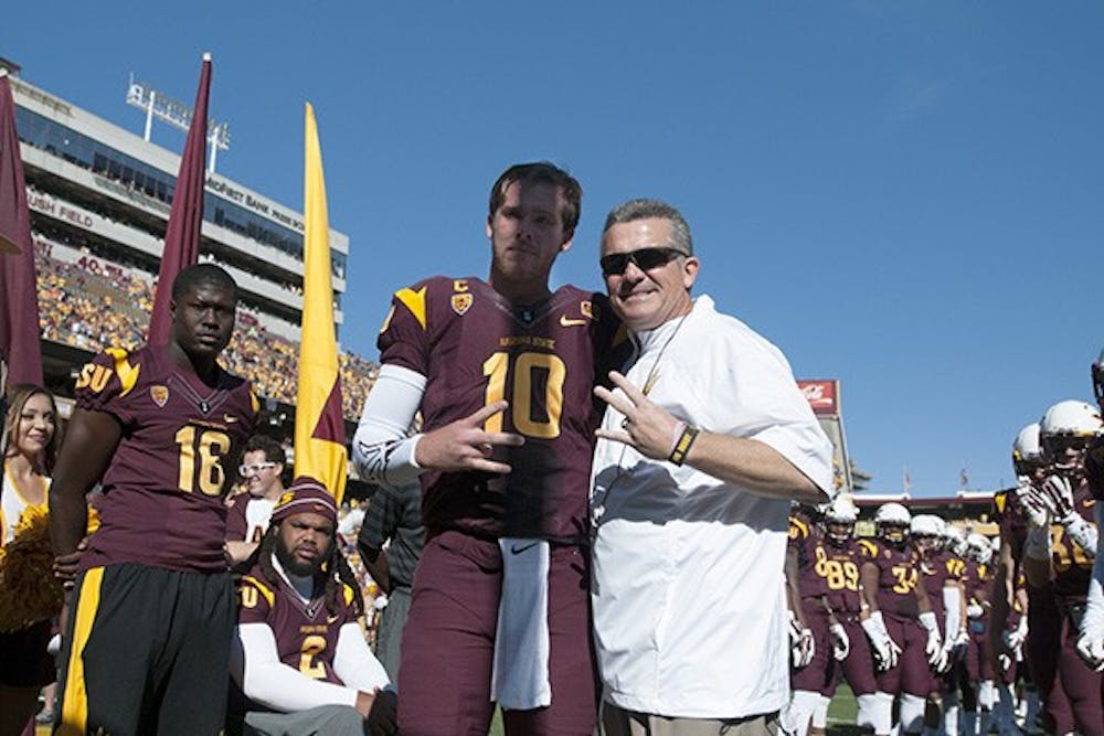 Senior quarterback Taylor Kelly poses with Coach Todd Graham before the last home game of the season. ASU beat Washington State 52-31 at Sun Devil Stadium on Saturday, Nov. 22, 2014. (Photo by Mario Mendez)