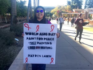Biomedical sciences student Shihomi Yazzie poses for a photo during an event hosted by HEAL International designed to bring attention to HIV and AIDS.
