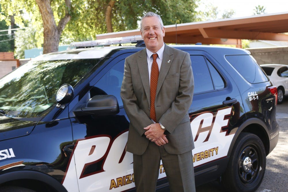 ASU police assistant chief Stuart Bedics poses for a photo outside the ASU police station by a squad car in Tempe, Arizona on Thursday, April 6, 2017.