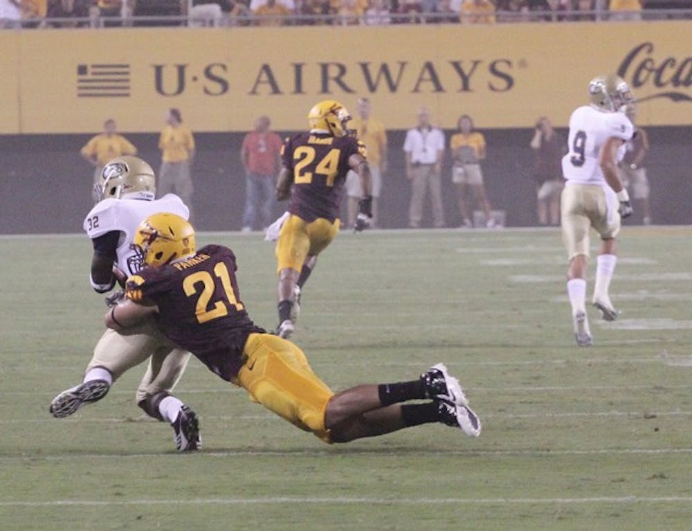 STIFLING: ASU redshirt senior linebacker Colin Parker makes an open-field tackle on UC Davis’ Marquis Nicolis during the Sun Devils’ victory on Thursday. ASU’s defense held the Aggies to just 214 yards of total offense. (Photo by Beth Easterbrook)