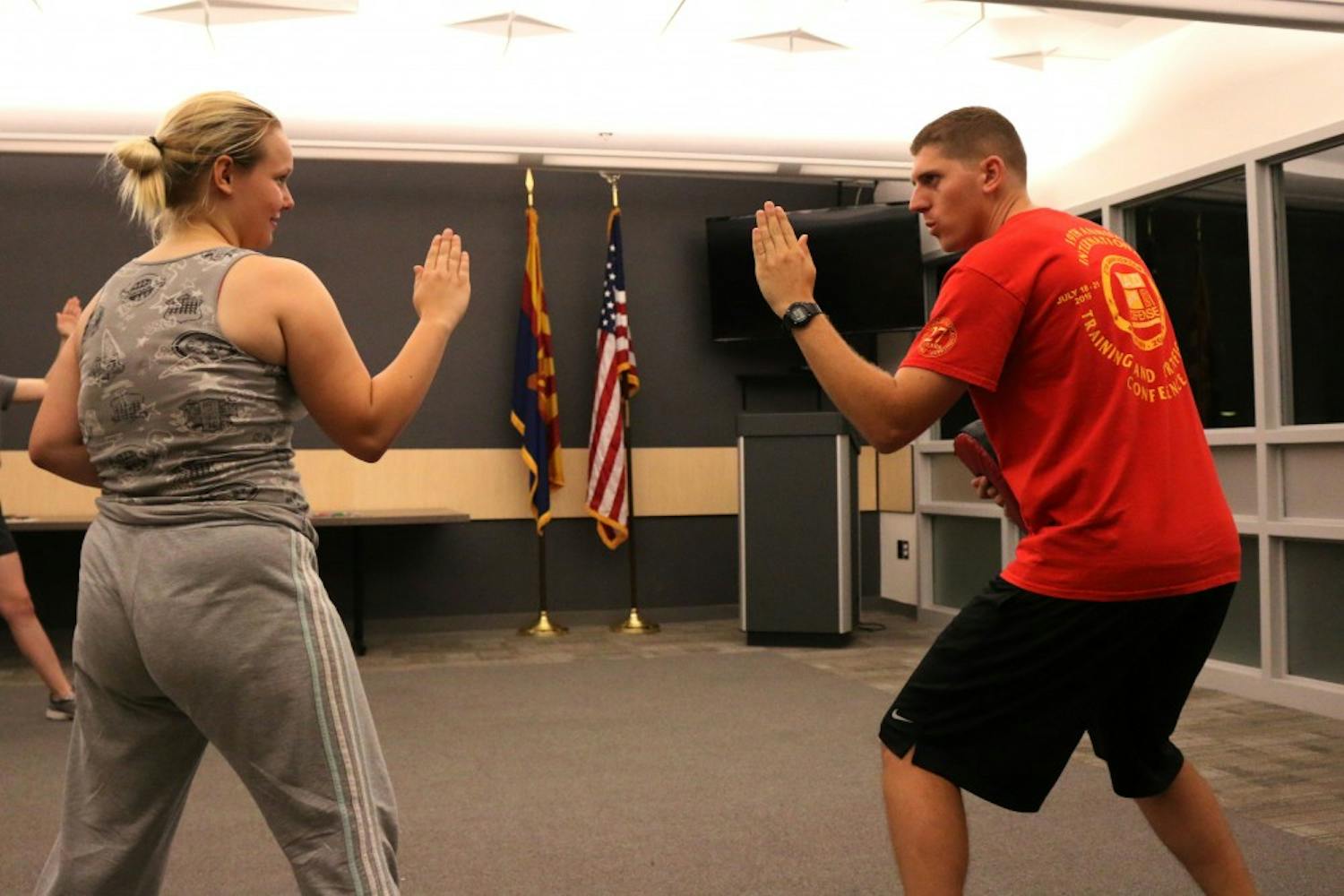 Officer Daniel Miller practices self defense with student Elizabeth Briet, an ASU freshman majoring in chemisty, at the ASU Tempe police station on Sept. 8, 2016. 