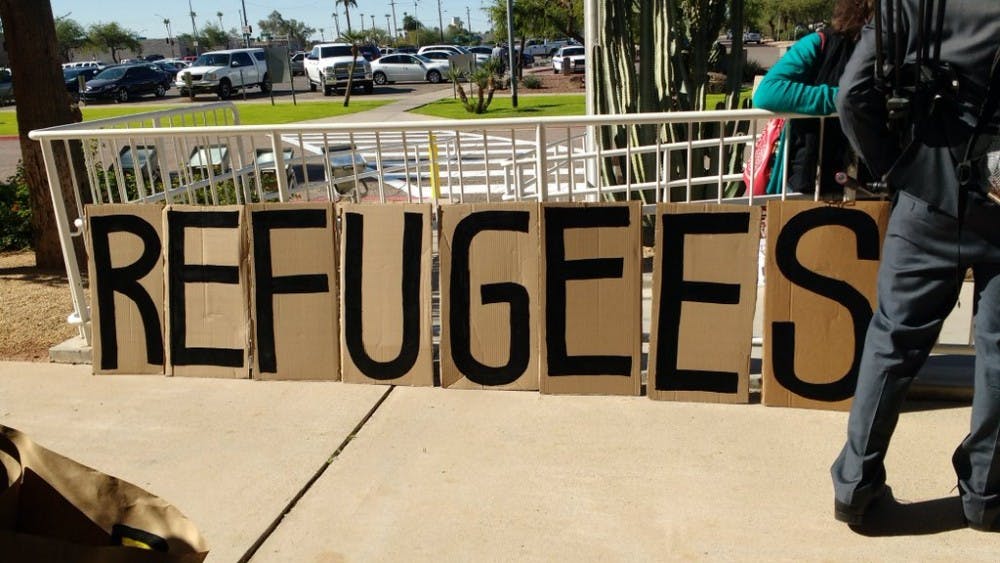 Around 30 protestors gathered on the lawn in front of the Gov. Doug Ducey's office&nbsp; at the Arizona State Capitol&nbsp;with signs denouncing his statement about not allowing Syrian refugees in Arizona on Nov. 17, 2015.