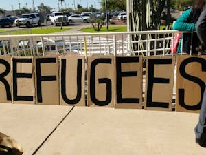 Around 30 protestors gathered on the lawn in front of the Gov. Doug Ducey's office&nbsp; at the Arizona State Capitol&nbsp;with signs denouncing his statement about not allowing Syrian refugees in Arizona on Nov. 17, 2015.