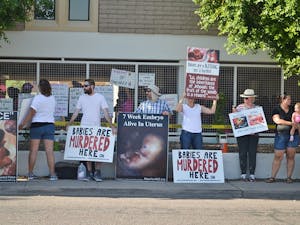 Protesters stand outside Planned Parenthood in downtown Phoenix on Saturday, Aug. 22, 2015.