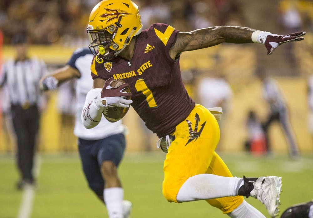 ASU freshman N'Keal Harry breaks a tackle during the first half of a game against Northern Arizona University in Sun Devil Stadium in Tempe, Arizona, in Sept. 3, 2016. 