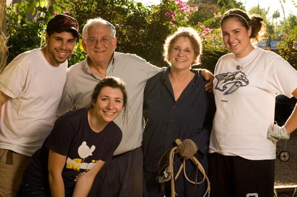 WHAT A MENSCH: Rabbi Lee and his wife Marcie gather with ASU Hillel members for the annual building of the Sukkah, part of the festive Jewish holiday of Sukkot. (Photo by Aaron Lavinsky)