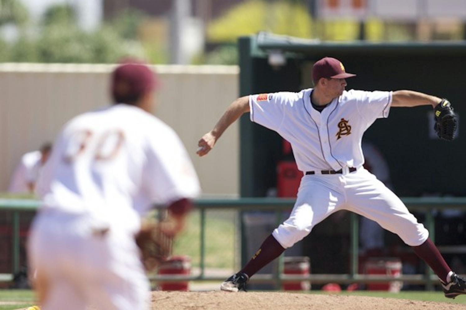 Back in stride: ASU sophomore Jake Barrett pitches as junior infielder Riccio Torrez looks on during the Sun Devils’ 10-4 win over Washington State on Sunday. Barrett picked up the win as ASU completed the sweep over the Cougars. (Photo by Scott Stuk)