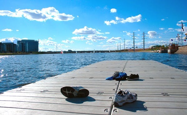 COOLING OFF: Tempe residents kicked off their shoes in cooler February weather to enjoy a sunny day at Tempe Town Lake, with activities ranging from fishing to sailboating and enjoying picnics on the grass. (Photo by Lisa Bartoli)