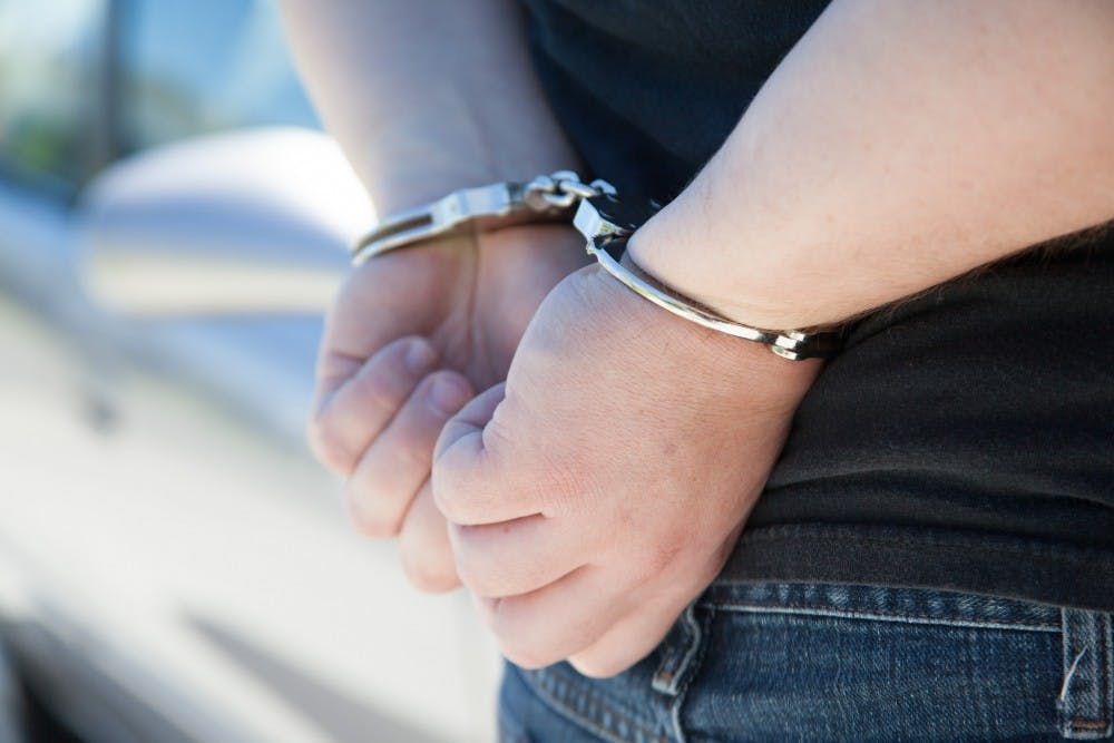 Photo illustration of a man handcuffed on June 18, 2014.