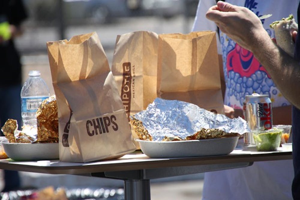 BURRITO TIME: Students eat free Chipotle at a Honda promotional event on the north side of the Tempe campus on Thursday. (Photo by Rosie Gochnour)
