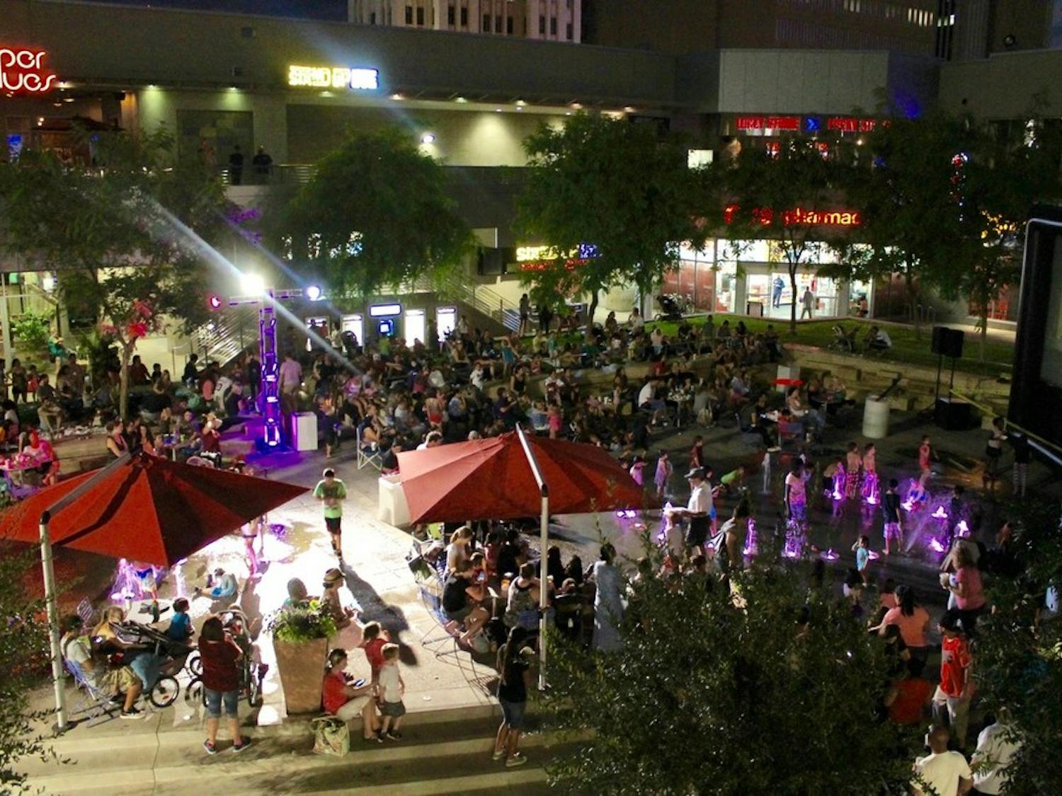 People watch movies as part of 'City Lights Movie Nights' at CityScape in downtown Phoenix in July 2015.