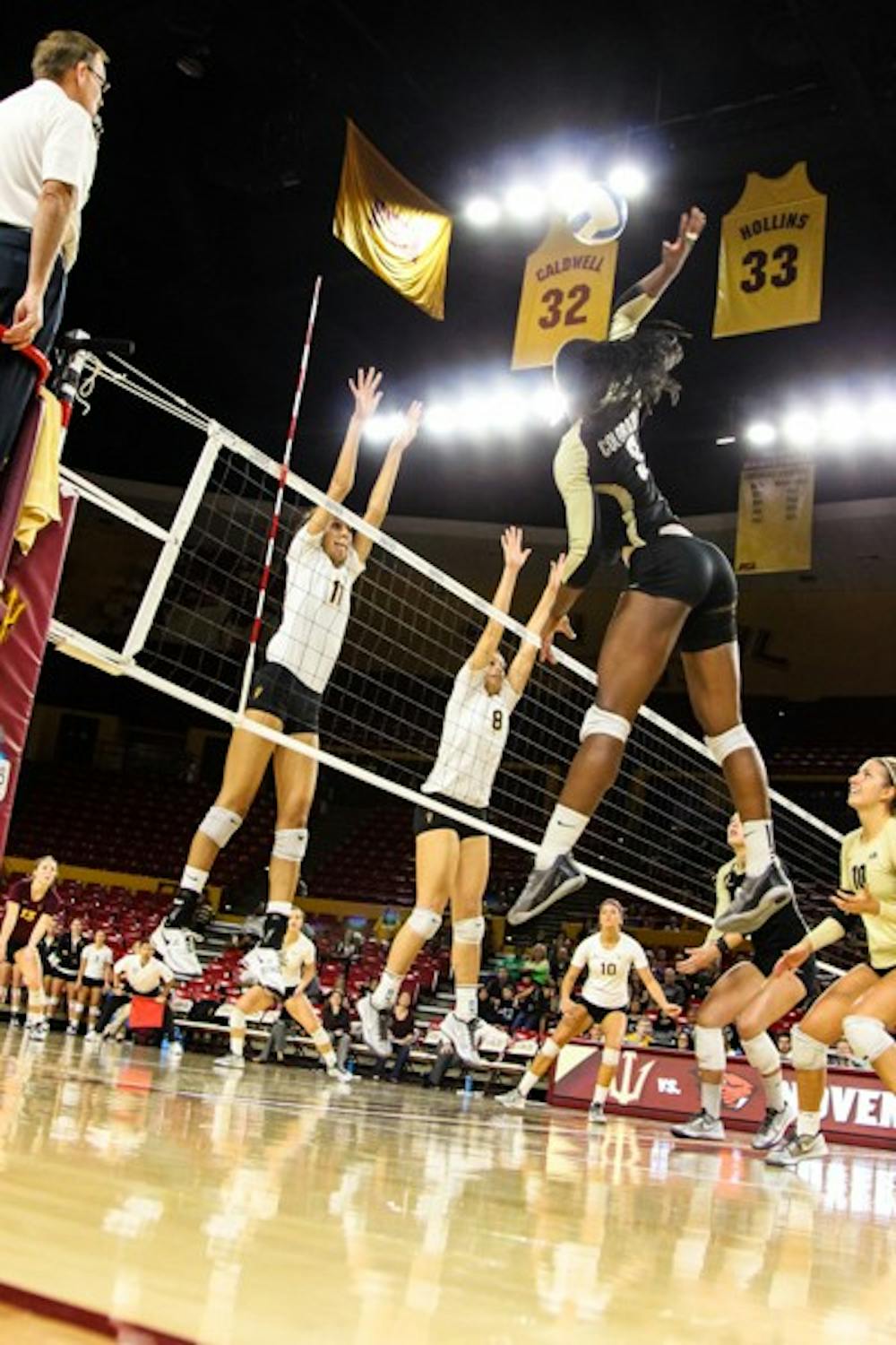 Sophomore outside hitter BreElle Bailey and junior middle blocker Whitney Follette go up for a block during the second set of the game against Colorado on November 2nd, 2014. The Sun Devils' late comeback attempt came up short vs the Buffs as they lost 3-2. (Photo by Daniel Kwon)