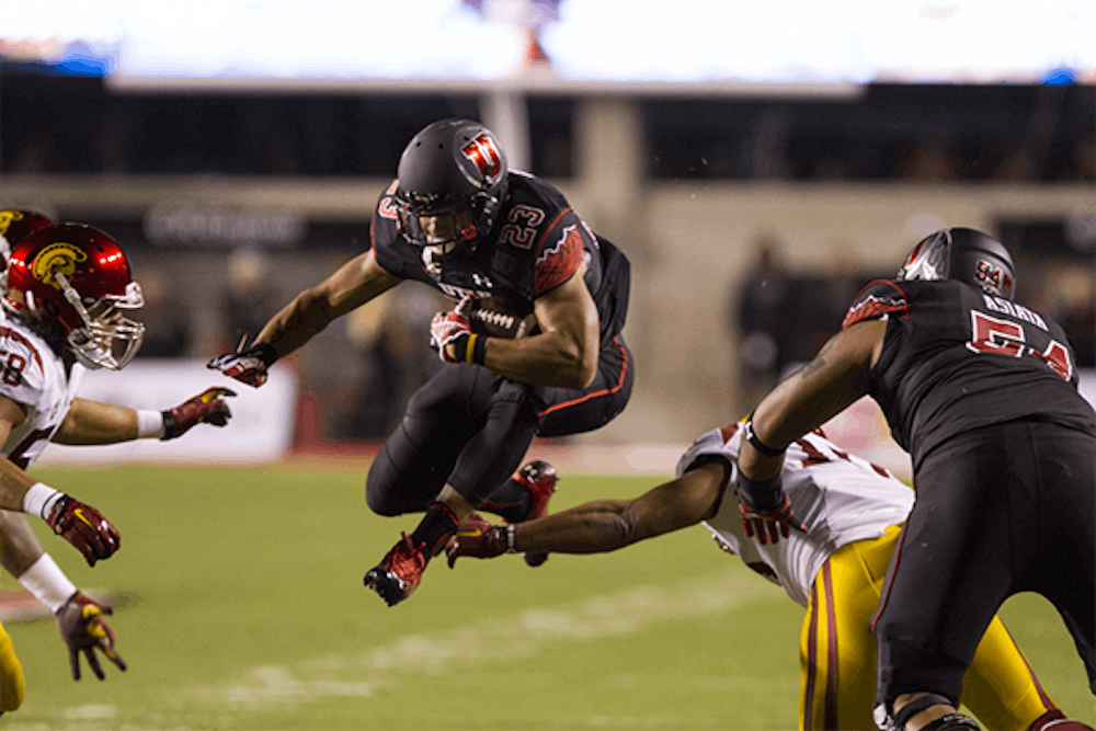 Utah junior running back Devontae Booker runs with the ball in a game against USC. (Photo Courtesy of The Daily Utah Chronicle)