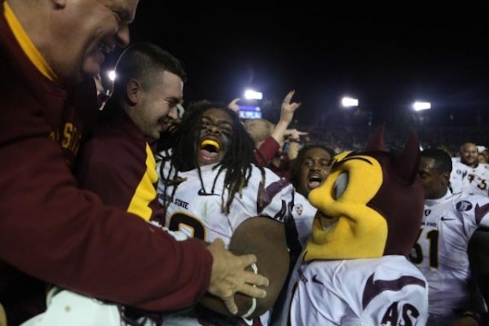 Redshirt senior defensive tackle Will Sutton celebrates with ASU fans and Sparky after the win over UCLA in Pasadena Calif., Saturday, Nov. 23. ASU defeated the Bruins 38-33 and clinched a spot in the Pac-12 championship. (Photo by Dominic Valente.)