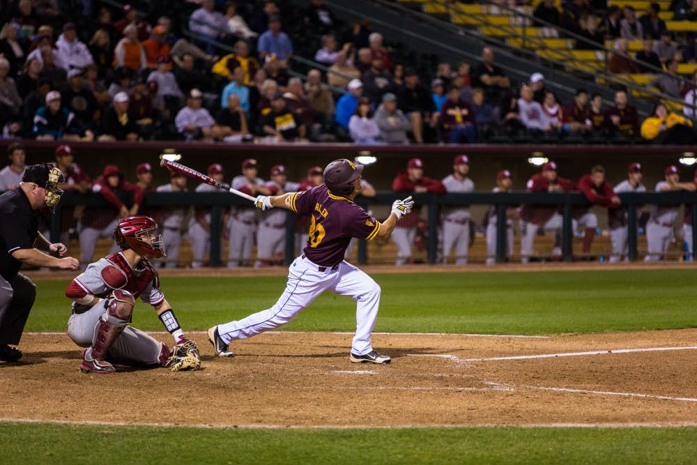 ASU redshirt senior right fielder Trever Allen hits a single in the 7th inning at the ASU vs. Oklahoma baseball game at Phoenix Municipal Stadium on Feb. 18, 2015. Allen’s single was a part of the five-run explosion in the bottom of the 7th for the Sun Devils. (Daniel Kwon/The State Press)