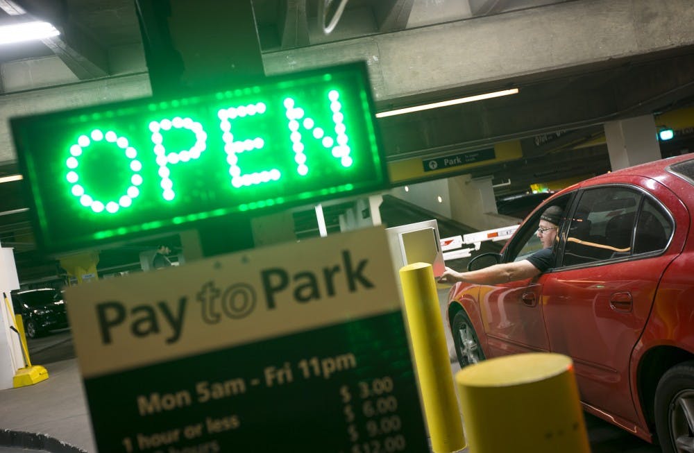 Jeff McSpadden pays for parking in the University Center parking garage on the Downtown Phoenix campus on Wednesday, Sept. 21, 2016.
