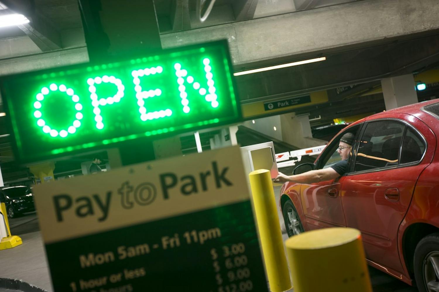 Jeff McSpadden pays for parking in the University Center parking garage on the Downtown Phoenix campus on Wednesday, Sept. 21, 2016.