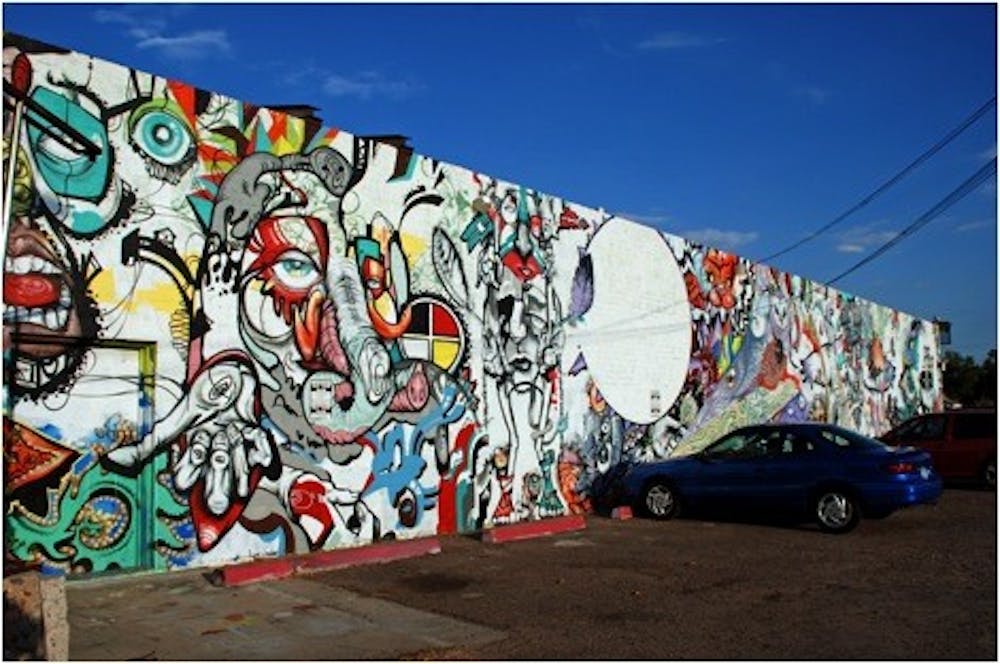 Artist Joerael Elliott’s mural outside of Hair Pollution. Photo by Candace Porth. 