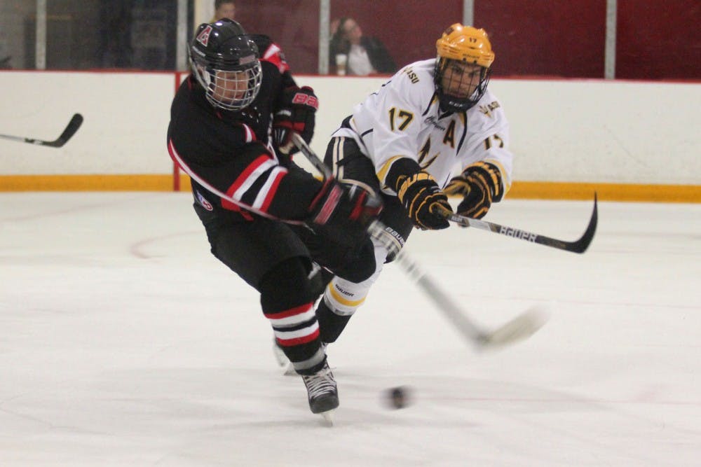Forward Kale Dolinski battles for the puck against San Diego State. Dolinski and goalie Robert Levin both won player of the month awards. (Photo by Diana Lustig)