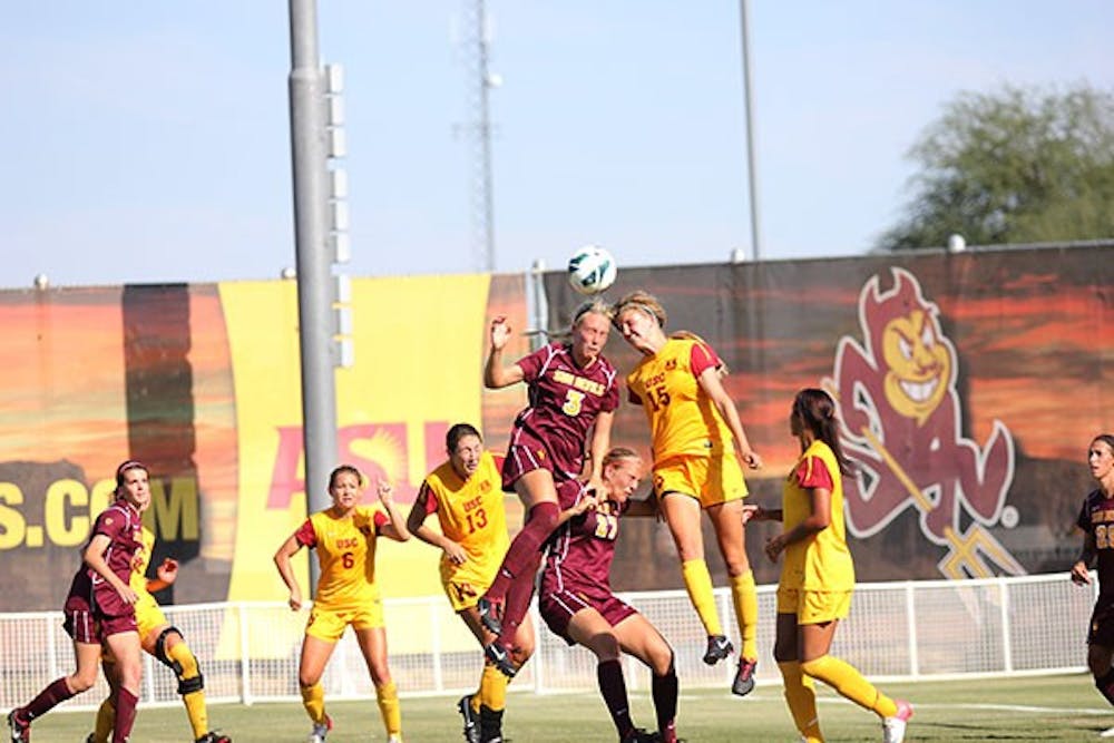 Sophomore defender McKenzie Berryhill heads the ball at a home game in Tempe.  (Photo by State Press Staff)