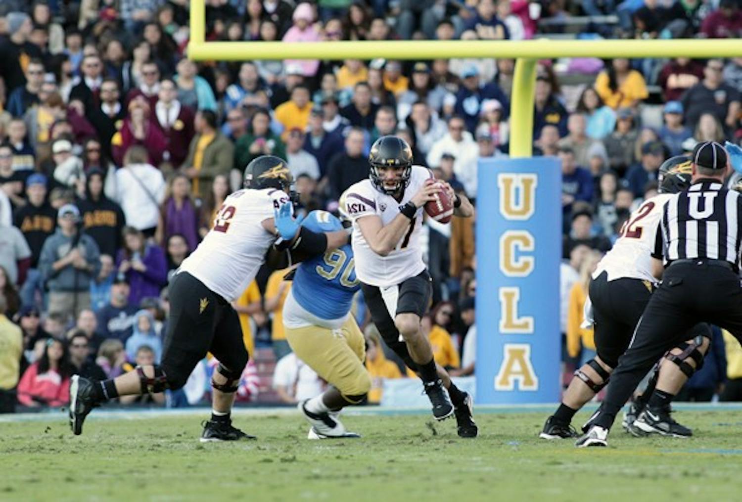 ASU junior quarterback Brock Osweiler runs up the middle during the Sun Devils’ loss to UCLA. The Sun Devils are headed to their first bowl game in four years. (Photo by Beth Easterbrook)