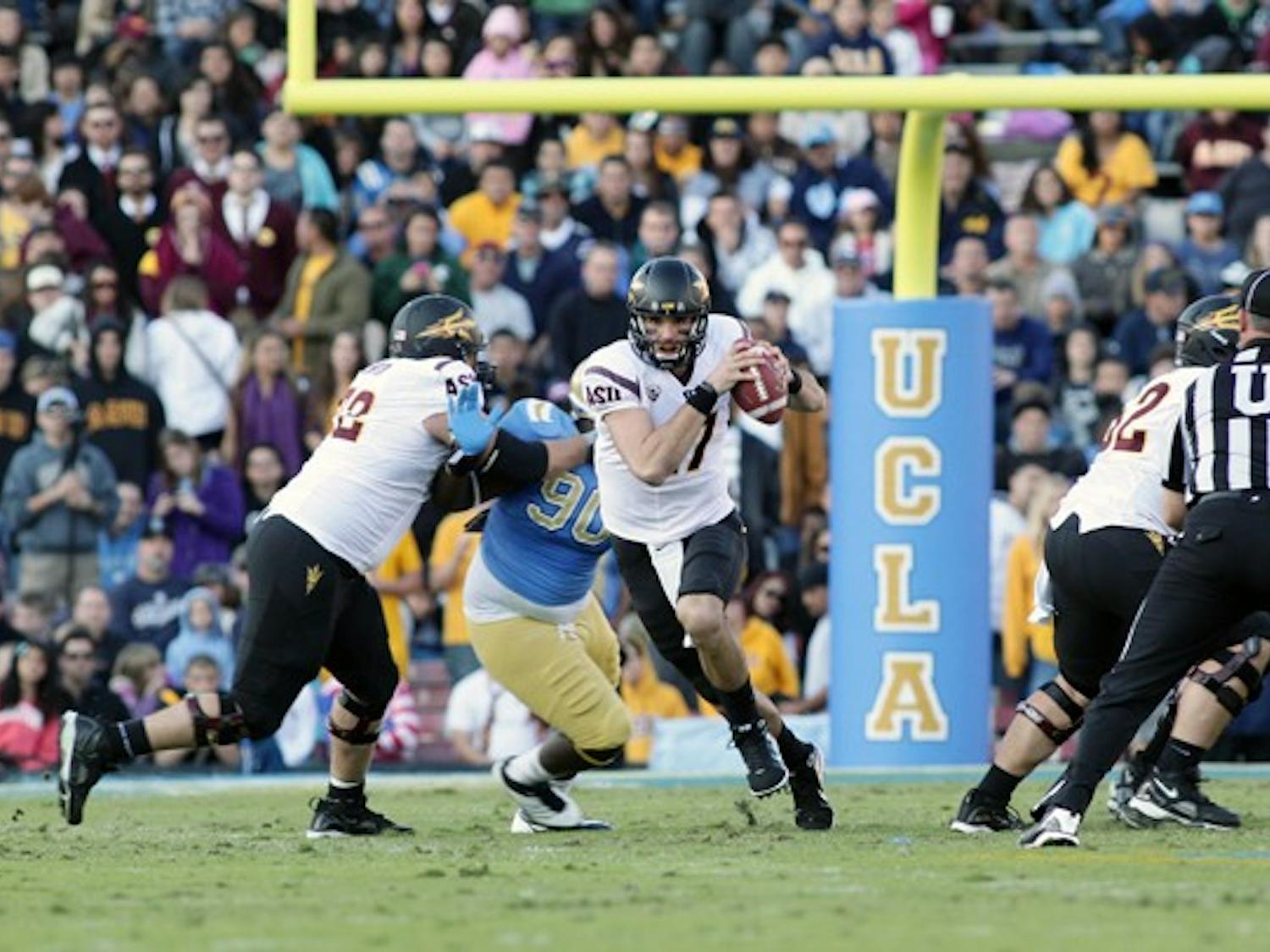 ASU junior quarterback Brock Osweiler runs up the middle during the Sun Devils’ loss to UCLA. The Sun Devils are headed to their first bowl game in four years. (Photo by Beth Easterbrook)