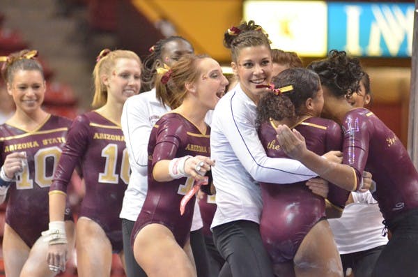Last Home Stand: The ASU gymnastics squad celebrates a high score from Beaté Jones against Oregon State on Feb. 6. The Sun Devils host their last home dual of the season Friday against Bridgeport. (Photo by Aaron Lavinsky)
