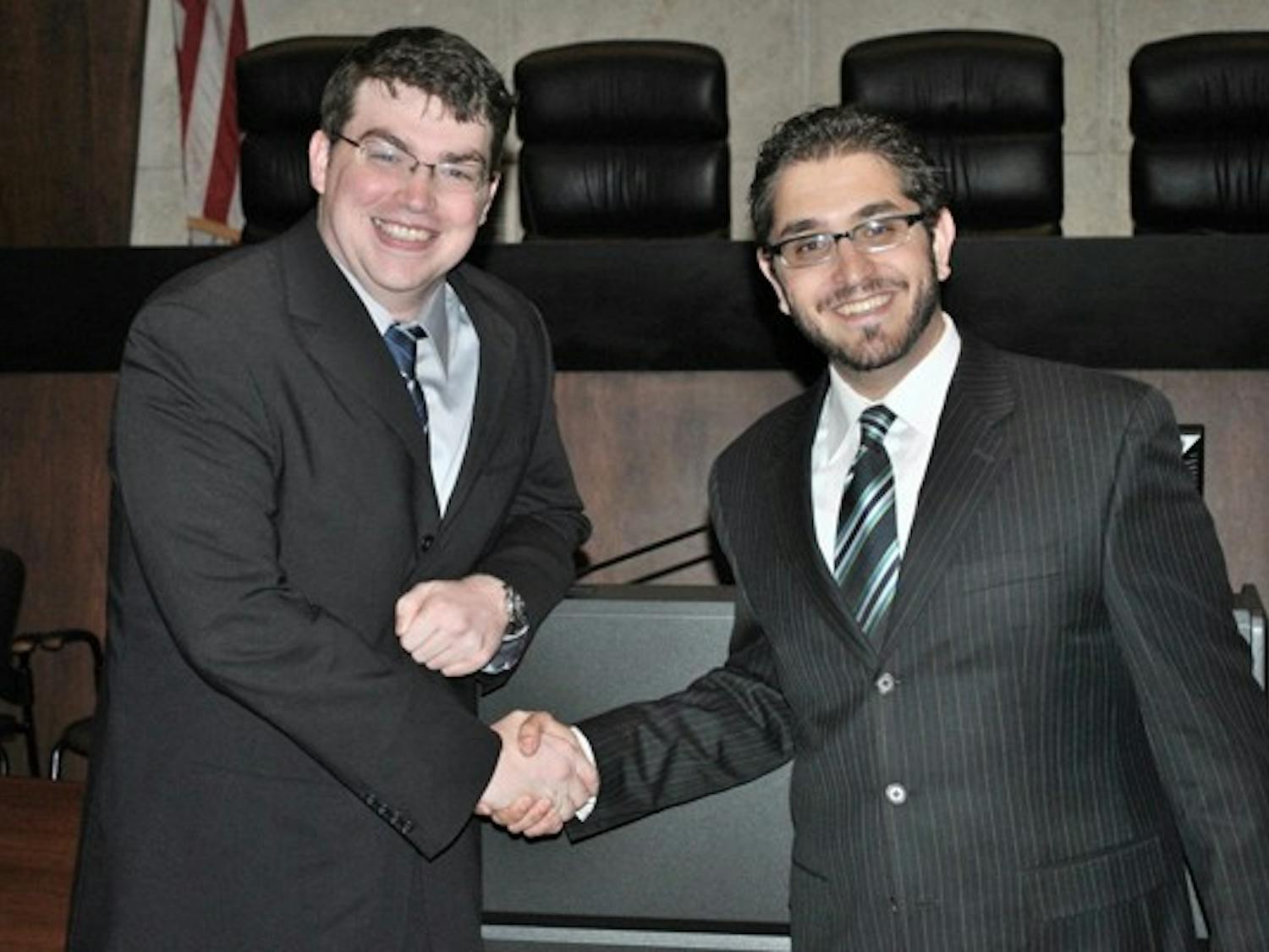 MAKING A POINT: First-year law students Daniel Hughes and Saman Golestan shake hands for a photo after winning both preliminary rounds of the Jenckes Closing Argument Competition Cup, in which participants prepare and deliver a closing argument for a closed case. (Photo Courtesy of Saman Golestan)