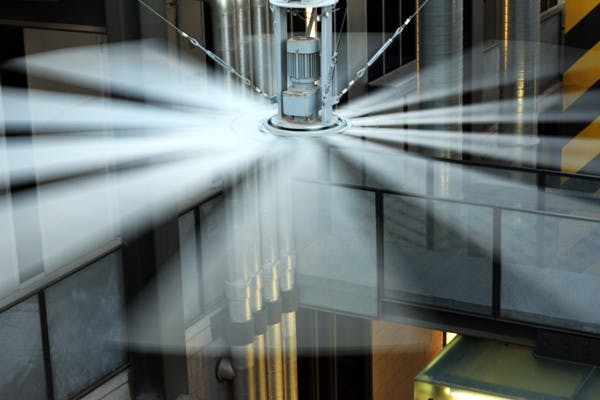 BIG SPINNER: A fan from the company Big Ass Fans spins slowly above the Interdisciplinary Science and Technology II Building on the Tempe campus Tuesday afternoon. (Photo by Lisa Bartoli)