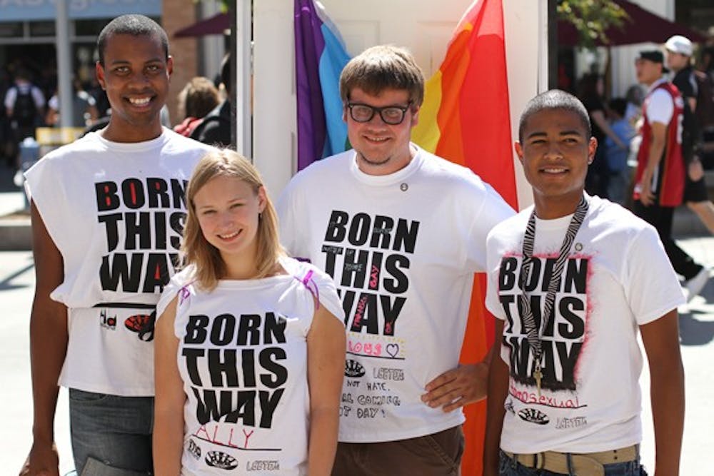 SHOWING PRIDE: Brian Fleming, Jackie Chikos, Oliver Migliore and Jessie Flores show off their "Born This Way" t-shirts outside of the Memorial Tuesday as part of the LGBTQA Coalition's Coming Out Day. (Photo by Lisa Bartoli)