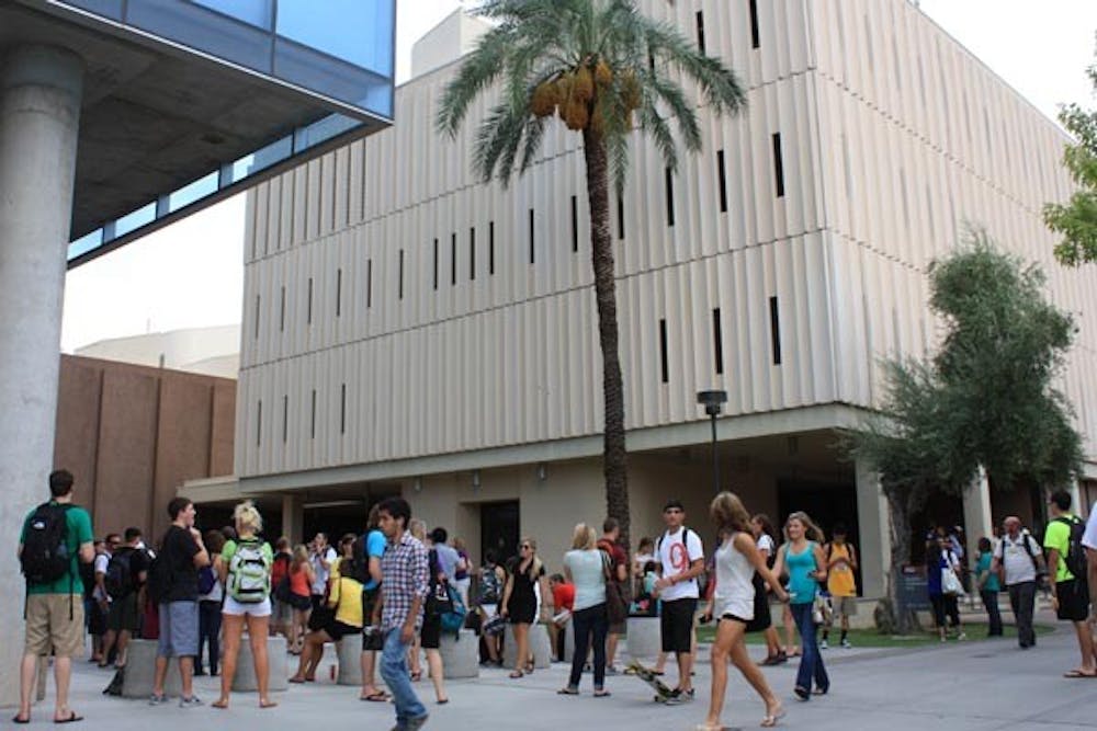 EMERGENCY EVACUATION: Students wait outside of the Stauffer Communication and Arts building after being evacuated Thursday afternoon because of smoke in the building. (Photo by Jessica Weisel)