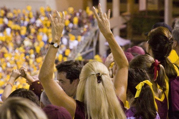 SHOWING SPIRIT: A Sun Devil fan flashes her pitchforks after ASU's second touchdown Saturday night against Oregon. (Photo by Annie Wechter)