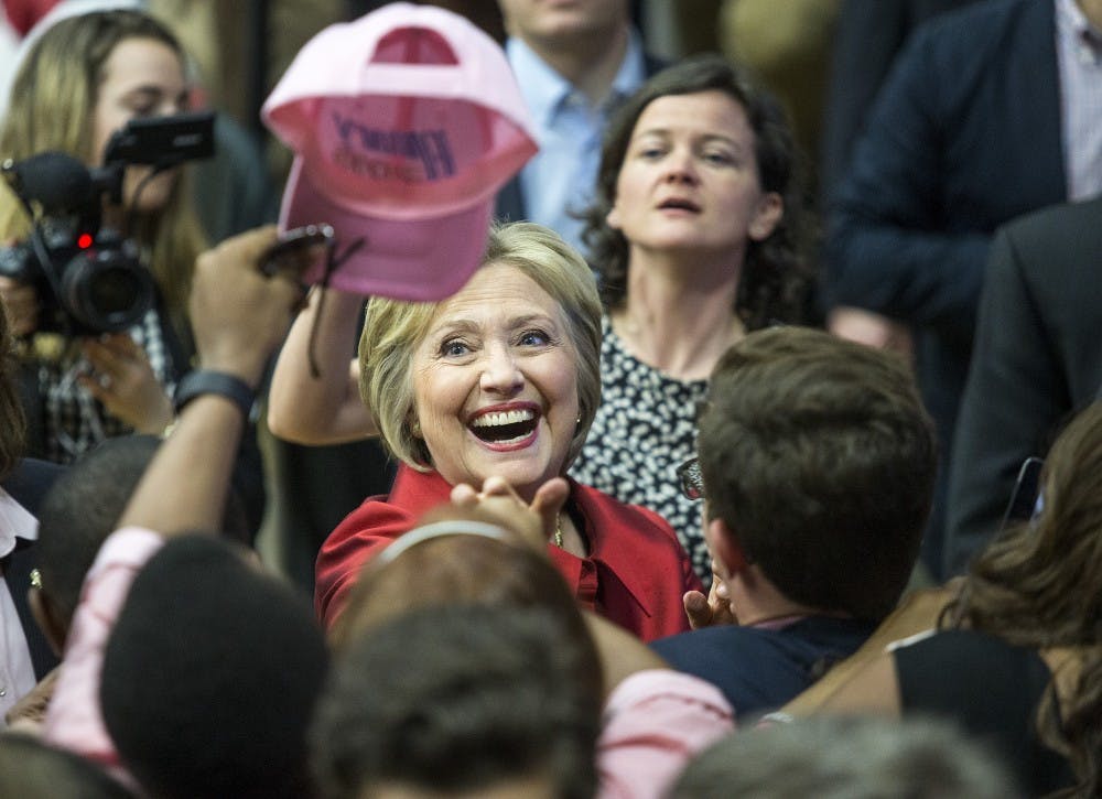 Democratic presidential candidate Hillary Clinton laughs as she looks at a supporter's hat during a campaign stop at Carl Hayden Community High School in Phoenix, Arizona, on Monday, March 21, 2016. 