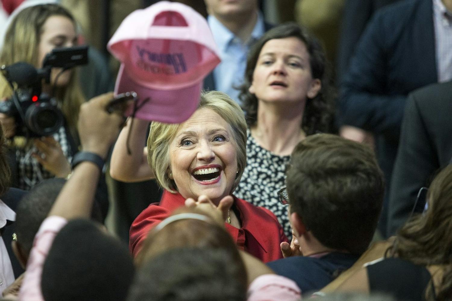 Democratic presidential candidate Hillary Clinton laughs as she looks at a supporter's hat during a campaign stop at Carl Hayden Community High School in Phoenix, Arizona, on Monday, March 21, 2016. 