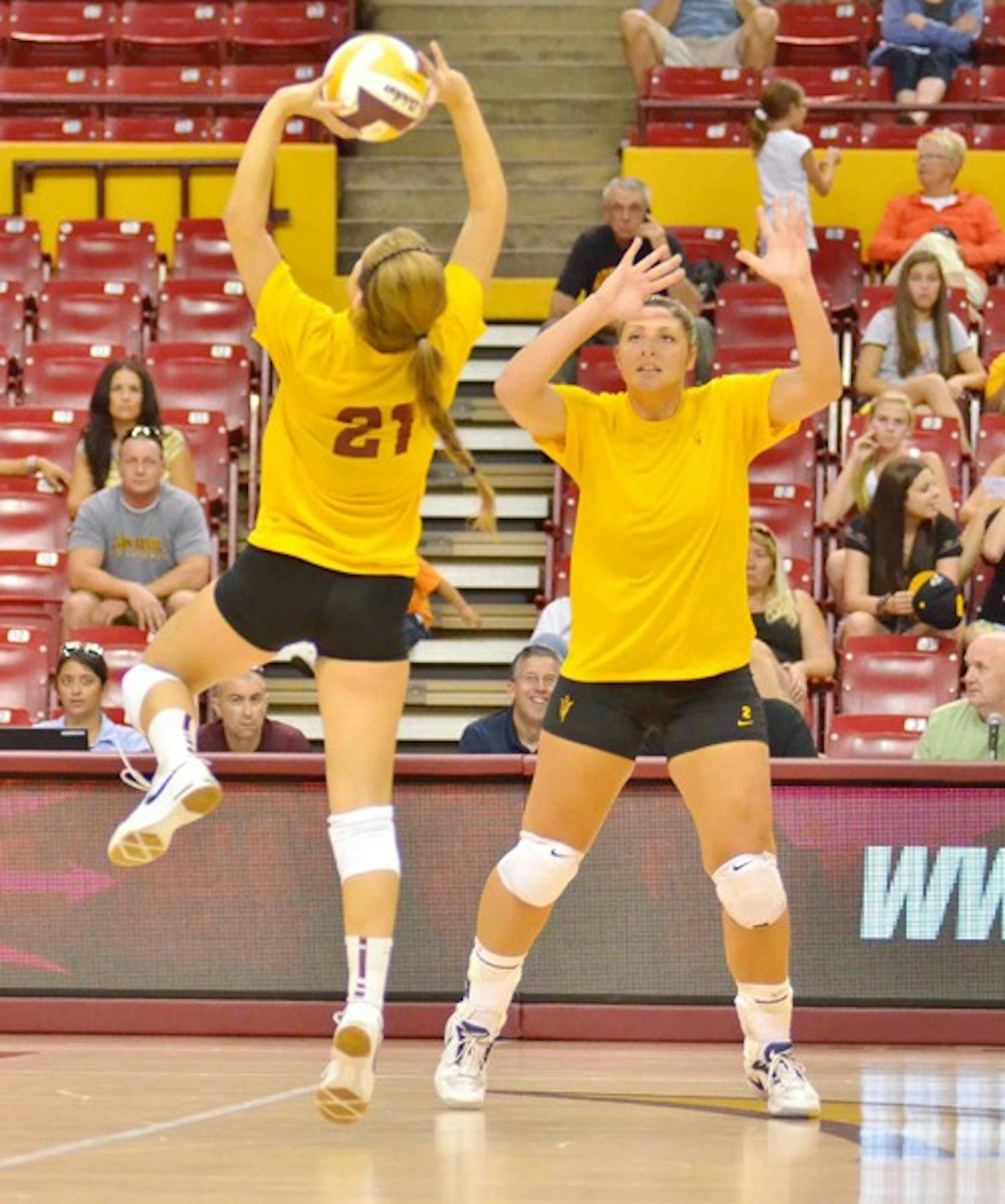 LEARNING WITH FILM: ASU sophomore setter Sarah McGaffin sets up a spike as senior middle blocker Sonja Markanovich (right) looks on during the Alumnae Game in August. Markanovich said that watching tape from the games would be a huge help this season. (Photo by Aaron Lavinsky)