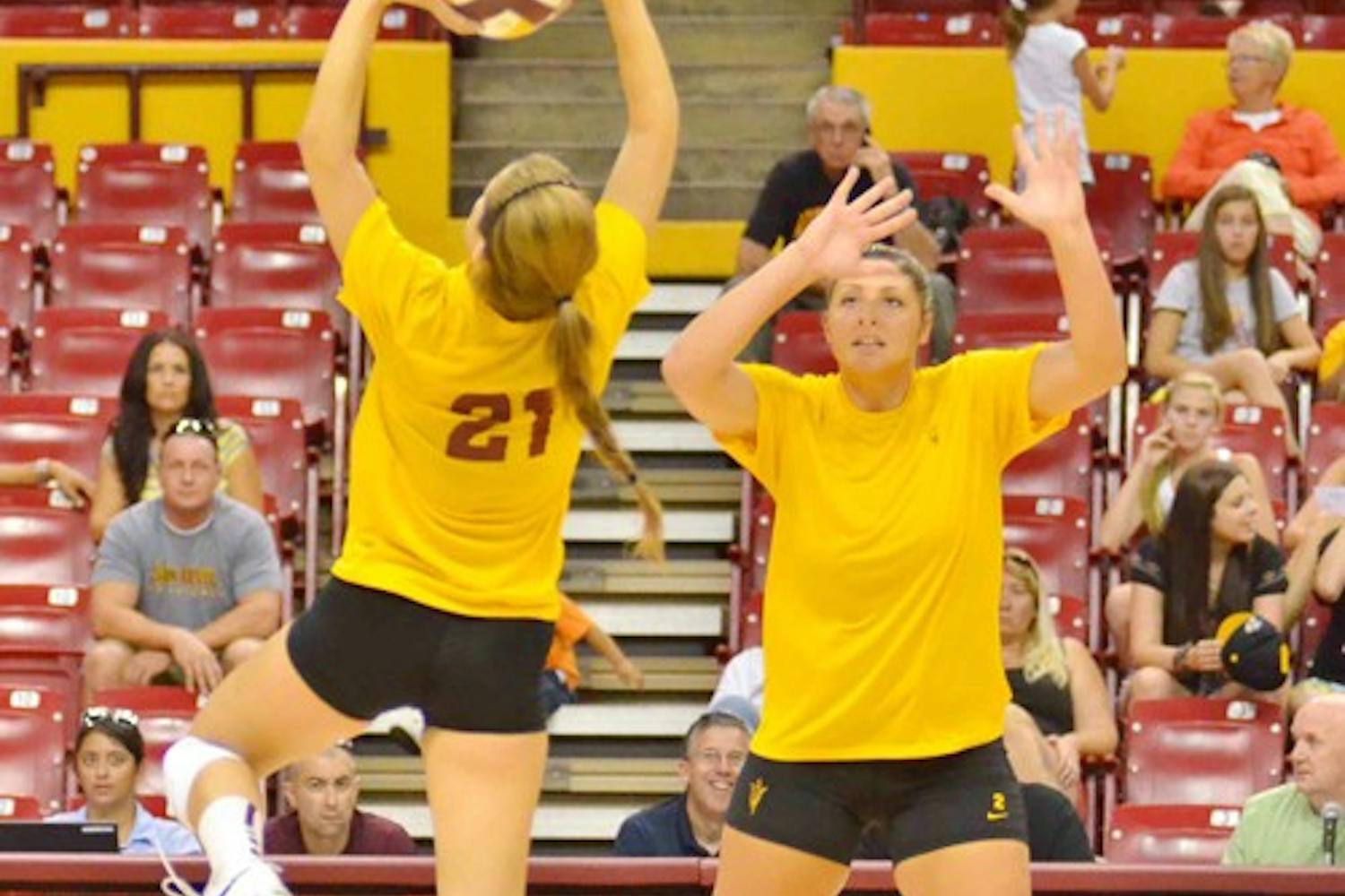 LEARNING WITH FILM: ASU sophomore setter Sarah McGaffin sets up a spike as senior middle blocker Sonja Markanovich (right) looks on during the Alumnae Game in August. Markanovich said that watching tape from the games would be a huge help this season. (Photo by Aaron Lavinsky)