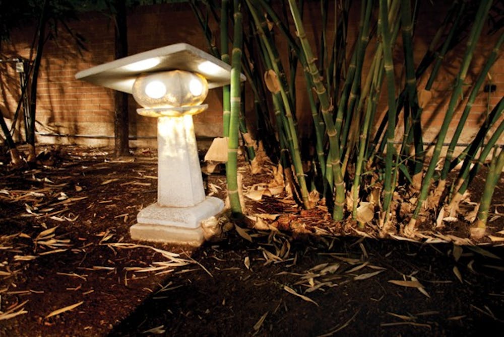 A light illuminates a bamboo garden on the Tempe campus at night. (Photo by Kurtis Semph)