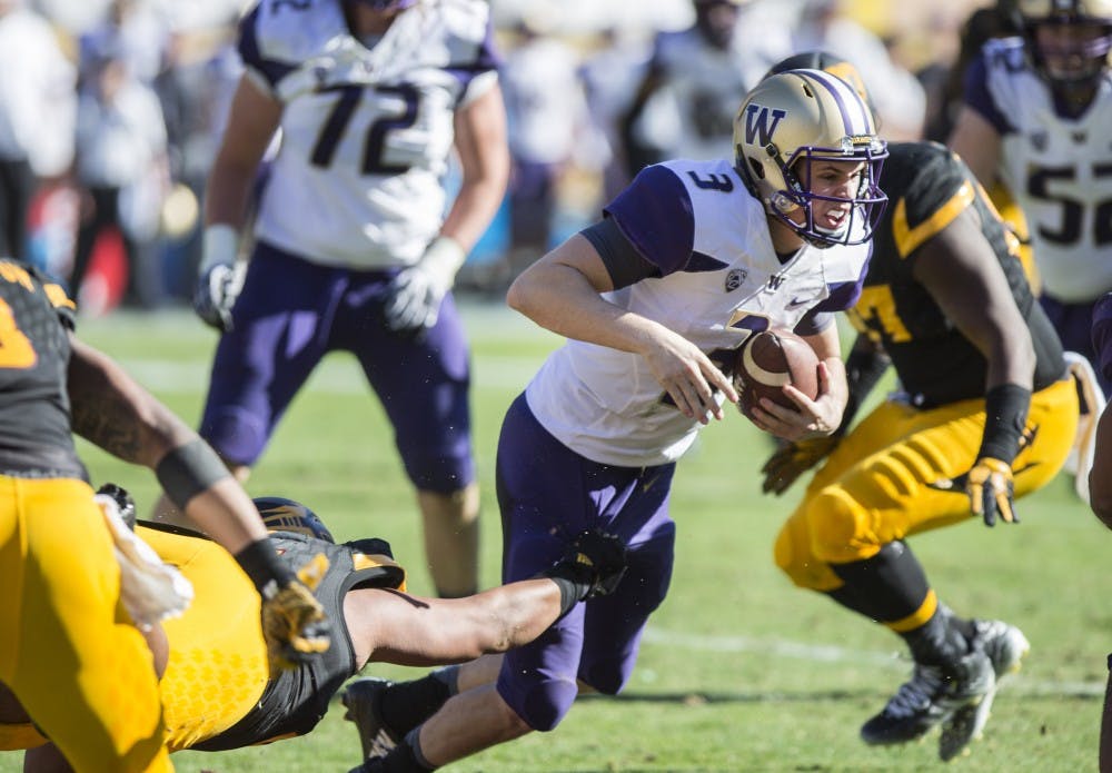 UW freshman quarterback Jake Browning avoids an ASU sack in the second quarter of a game on Saturday, Nov. 14, 2015, at Sun Devil Stadium in Tempe, Ariz. UW leads ASU 17-0 at the half. 