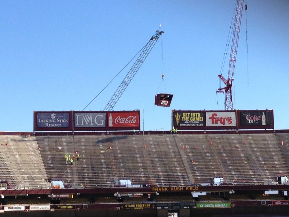 Construction crews begin removing the upper deck of Sun Devil Stadium on Monday, April 14. (Photo by Josh Nacion)