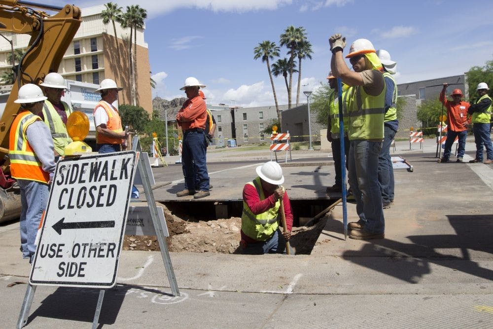 Construction workers excavate a piece of road near campus.The Tempe City Council’s decision to resurface Rural Road will extend traffic delays in the area to early November instead of the  end of October.