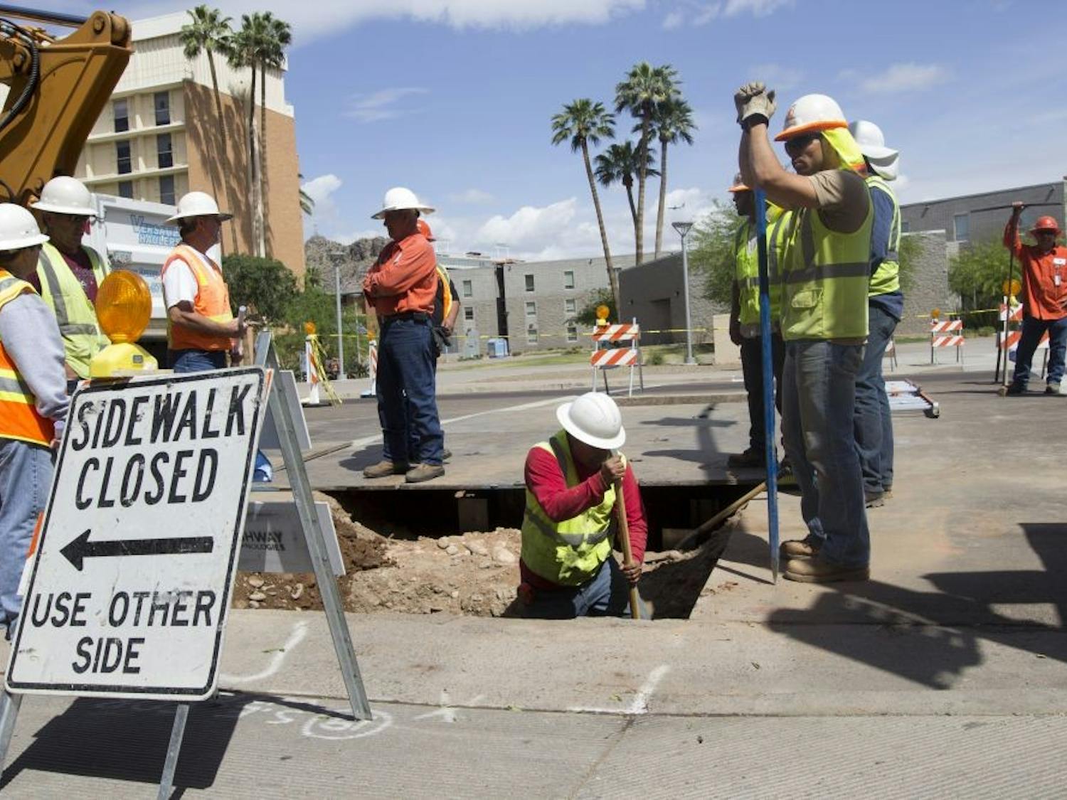 Construction workers excavate a piece of road near campus.The Tempe City Council’s decision to resurface Rural Road will extend traffic delays in the area to early November instead of the  end of October.