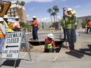 Construction workers excavate a piece of road near campus.The Tempe City Council’s decision to resurface Rural Road will extend traffic delays in the area to early November instead of the  end of October.
