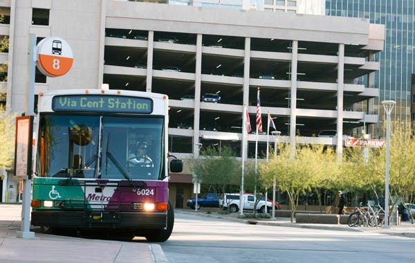 Metro bus Route 8 begins to drive away from the bus stop at the Central Station Transit Center on Tuesday. The Phoenix City Council approved a budget that will be used to purchase 120 buses that will use compressed natural gas. (Photo by Perla Farias)