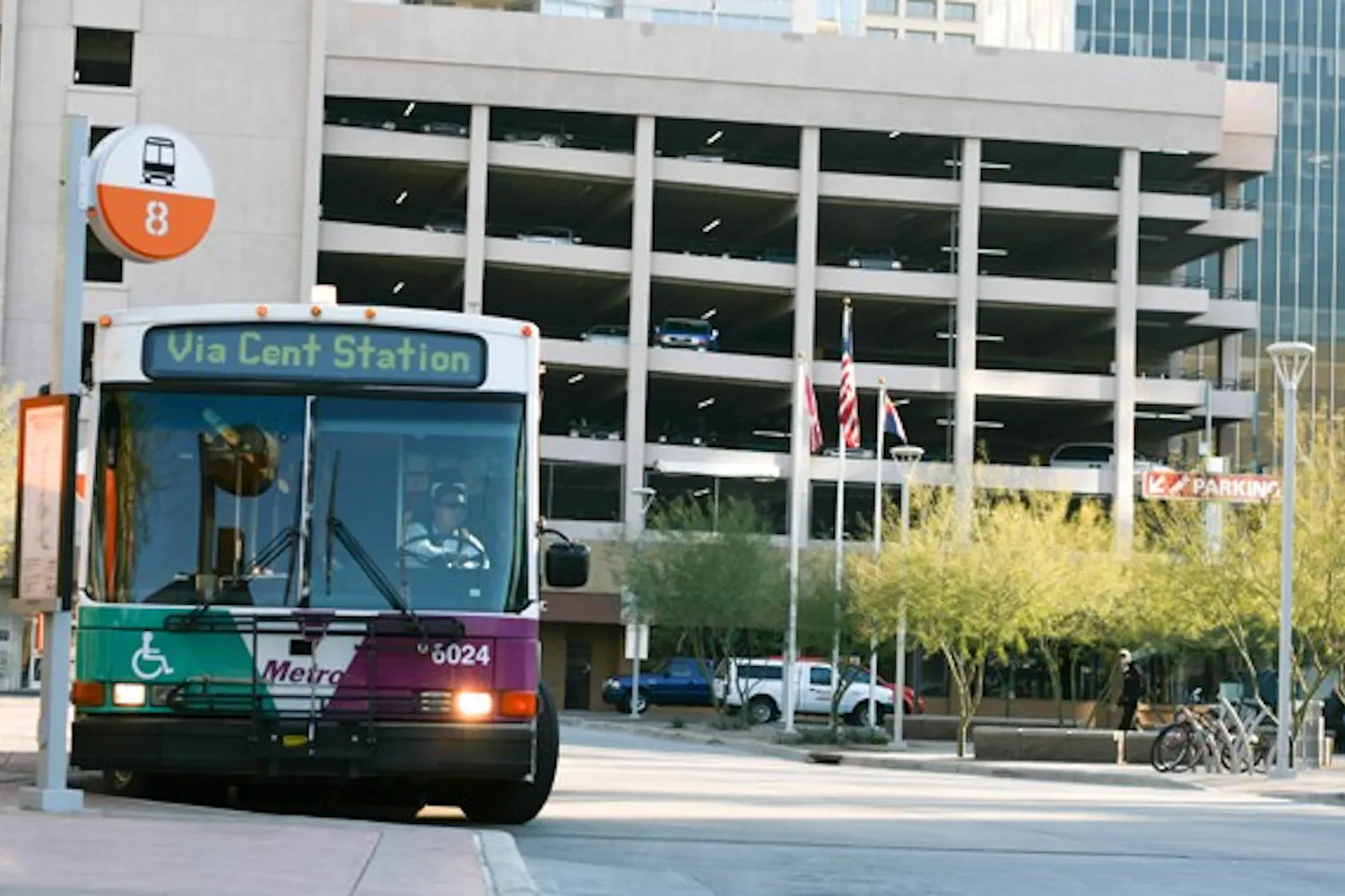 Metro bus Route 8 begins to drive away from the bus stop at the Central Station Transit Center on Tuesday. The Phoenix City Council approved a budget that will be used to purchase 120 buses that will use compressed natural gas. (Photo by Perla Farias)