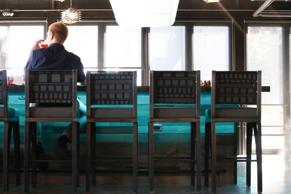 A man sits at the bar at the Found:re Hotel's Match restaurant in downtown Phoenix, Arizona.