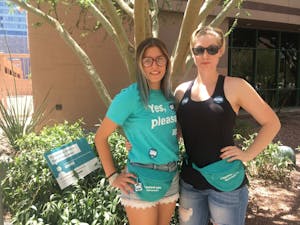 Jessica Woods and Tori Ward,&nbsp;peer educators for sexual violence, promote Denim Day on the downtown campus on April 26.&nbsp;