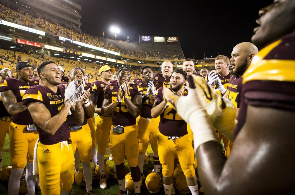 The ASU football team chants on the field after beating Cal Poly at Sun Devil Stadium in Tempe on Saturday, Sept. 12, 2015. ASU beat Cal Poly 35-21 in their season opener. 