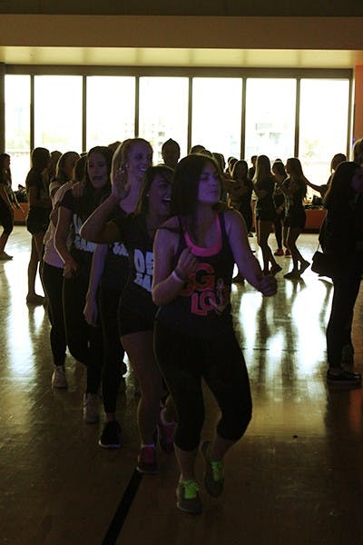 Students create a conga line  while dancing at the Dance Marathon on Feb. 22. (Photo by Alexis Macklin)